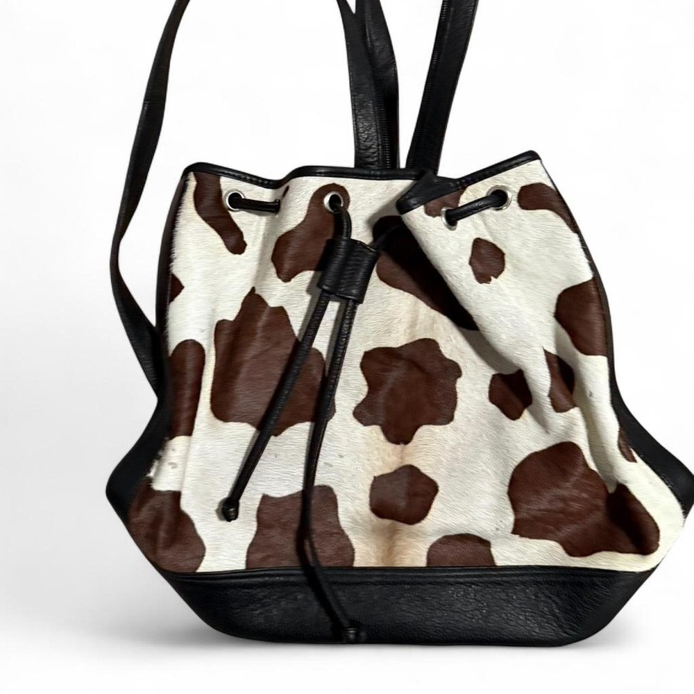 Brown and cream cow print leather bucket bag
